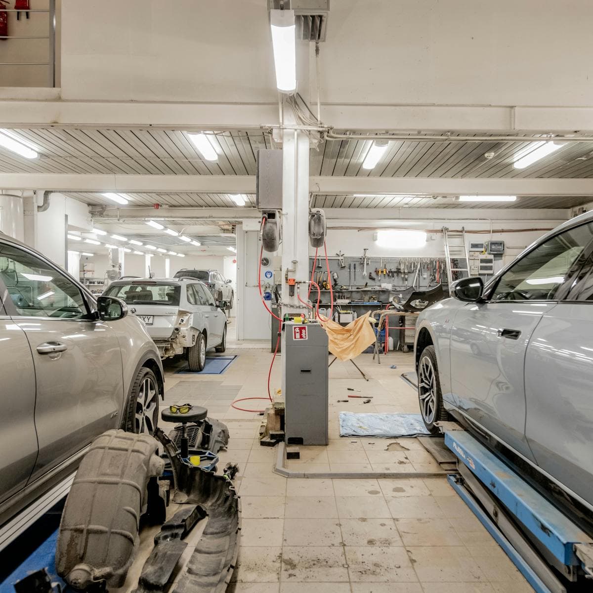 Vehicles undergoing collision repair in the Apex service bay