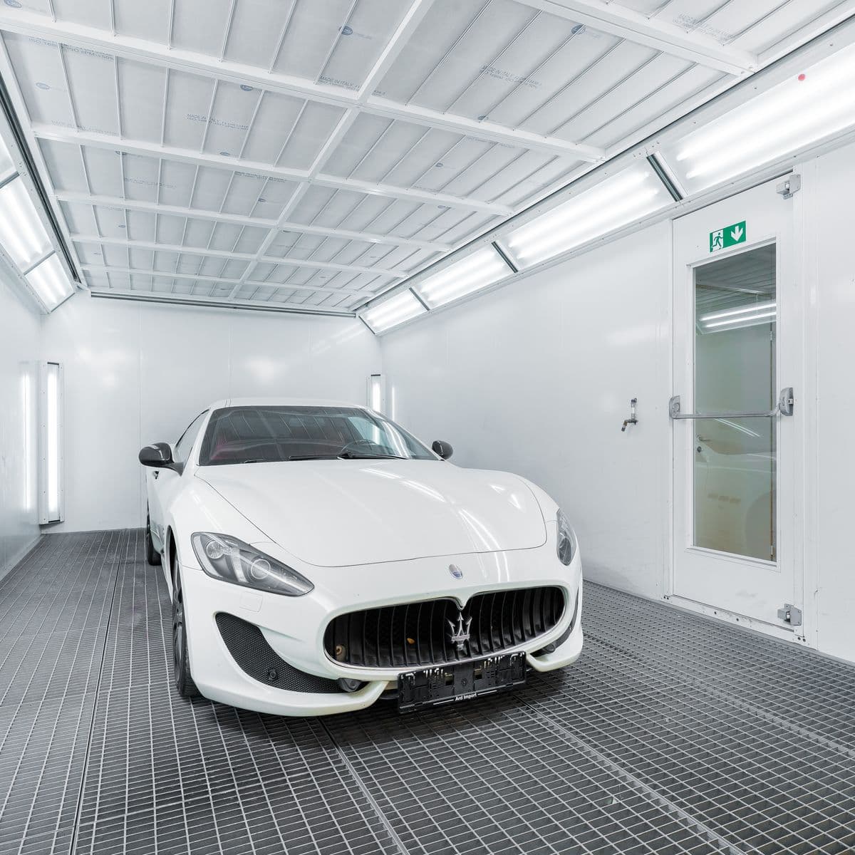 Vehicle in the climate-controlled downdraft paint booth